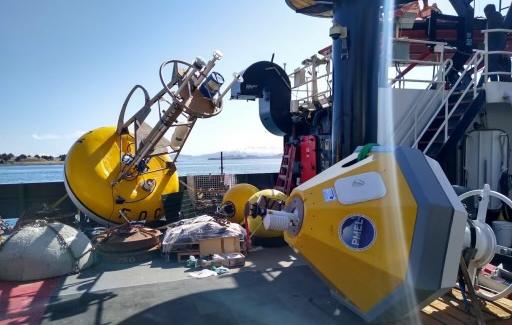 Two yellow buoys on a ship deck on a clear blue sky day