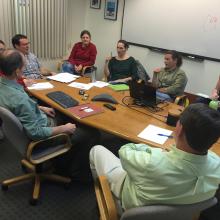 Engineers and scientists sitting together discussing the first phases of the mission.