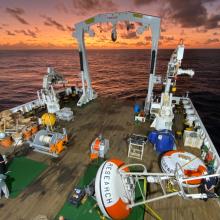 Two mooring orange and white buoy on the deck of the ship in the Indian Ocean during sunset