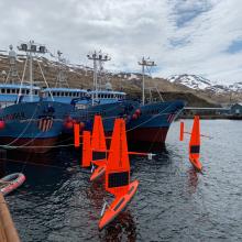 Three of six saildrones getting ready for deployment from Dutch Harbor, AK, on the 2019 Arctic mission