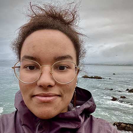 Christina with ocean and rocks in background